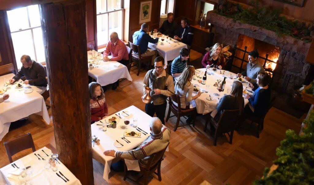 People sitting at tables in the dining room of the Mariposa restaurant at Deer Valley Resort