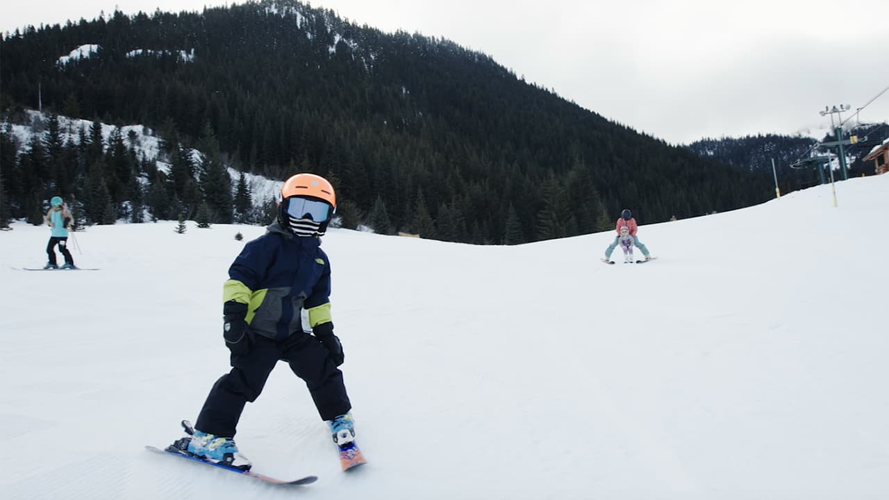Young boy taking a wide turn on a ski slope at Crystal Mountain Resort