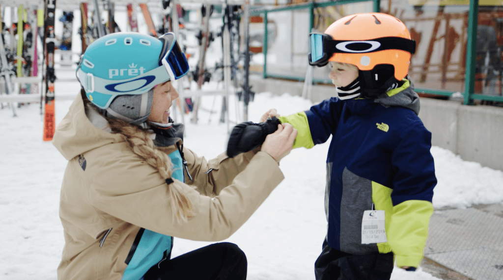 A mother and her son preparing for ski school