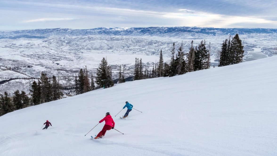 Skiers carving fresh powder on the slopes at Deer Valley Resort in Utah