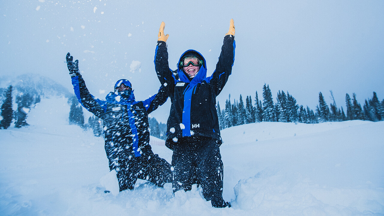 Two employees at Mammoth Mountain playing in the snow. Bring the snow, embrace the ritual.