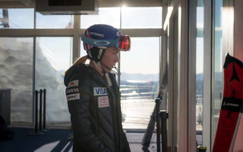 Mikaela Shiffrin standing inside with her ski helmet and goggles on