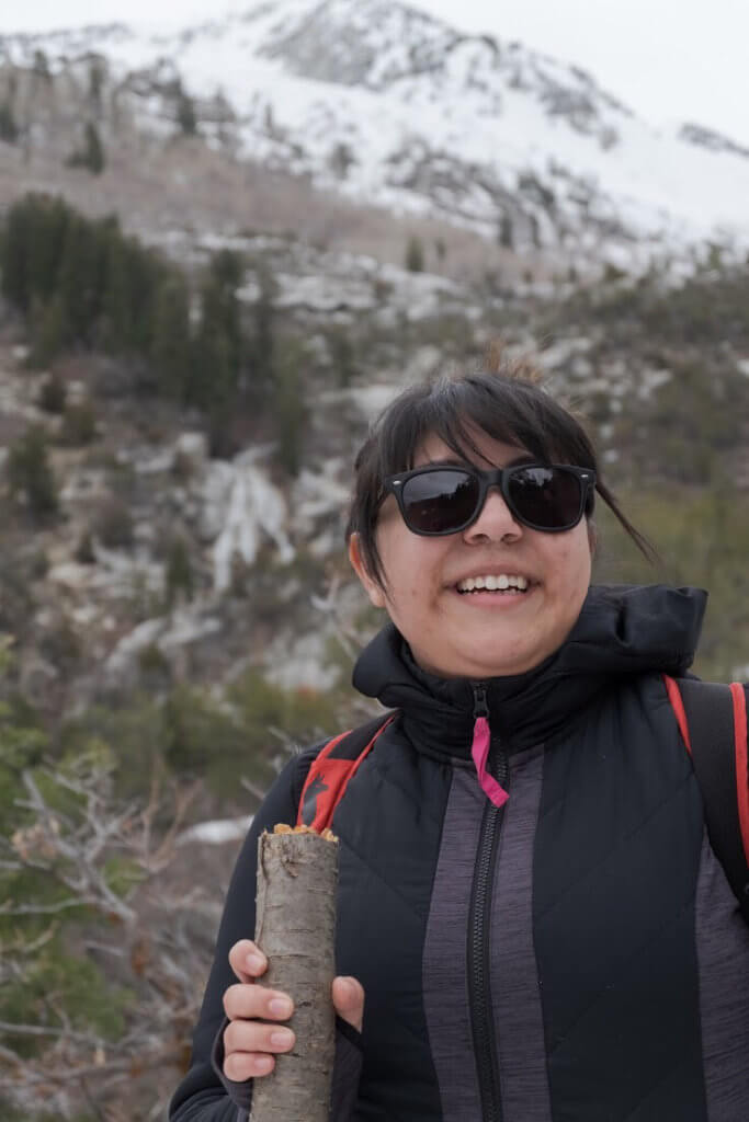 Close up of Dione Rodriguez, a BIPOC woman hiking in the mountains