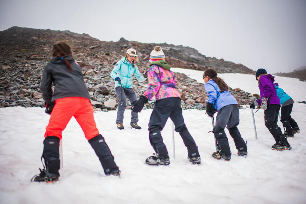 Young girls learning from their instructor during a Wild Skills course that helps girls and women get on the mountain