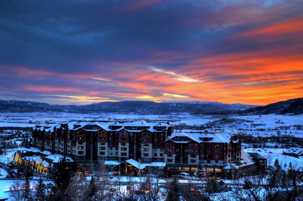 Scenic snowy view of the Steamboat Grand hotel during sunset