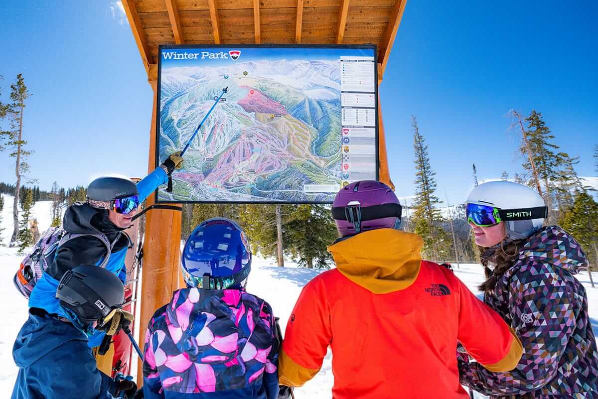 Skiers viewing a trail map at Winter Park