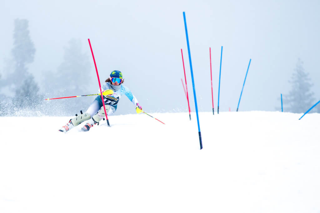 Skier racing through gates on a ski race course