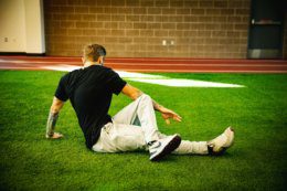 Person sitting on the ground stretching