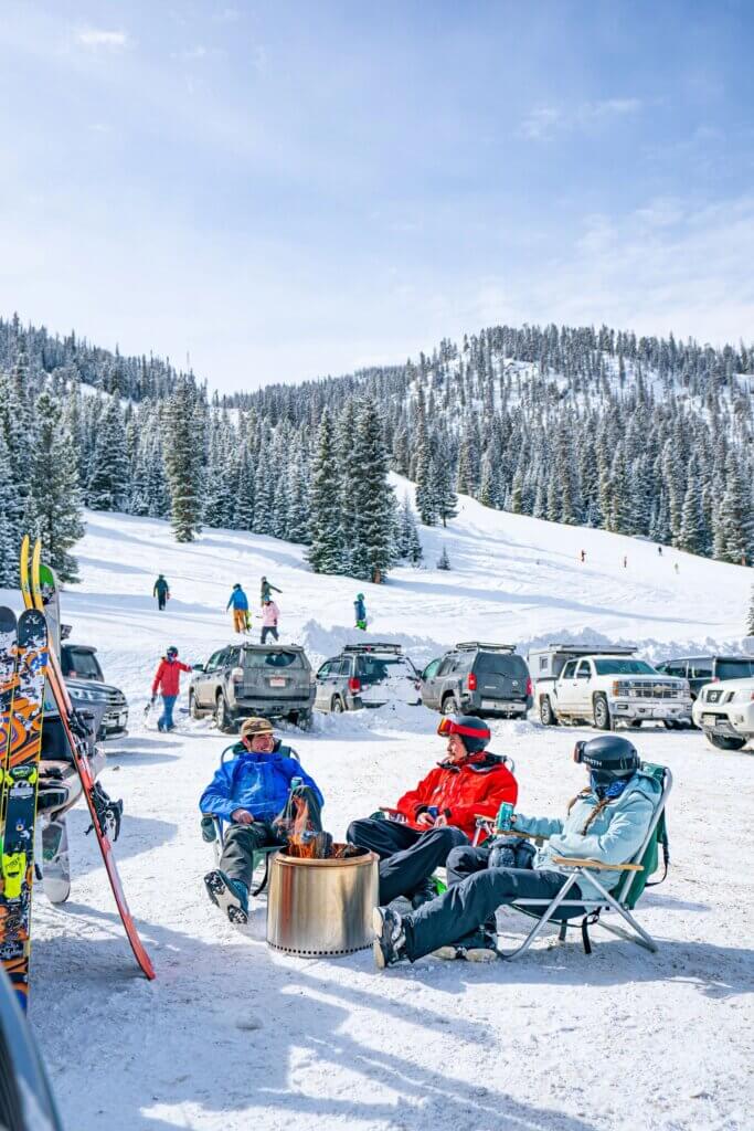 Skiers and snowboarders hanging at The Jane at Winter Park, one of the best mountain beach scenes 