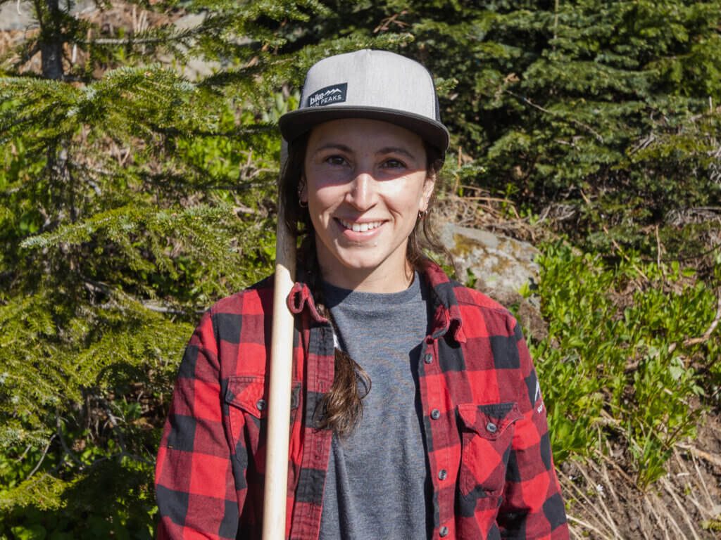 Person wearing a hat smiling into the camera