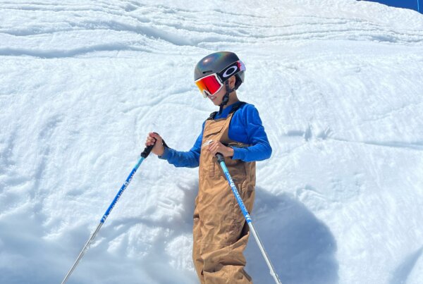 Person in ski gear standing in front of a pile of snow