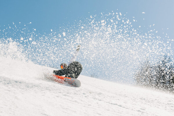 Snowboarder kicks up fresh powder while riding.