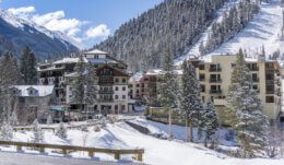 Scenic view of a hotel at the base of the trails on a blue sky day.