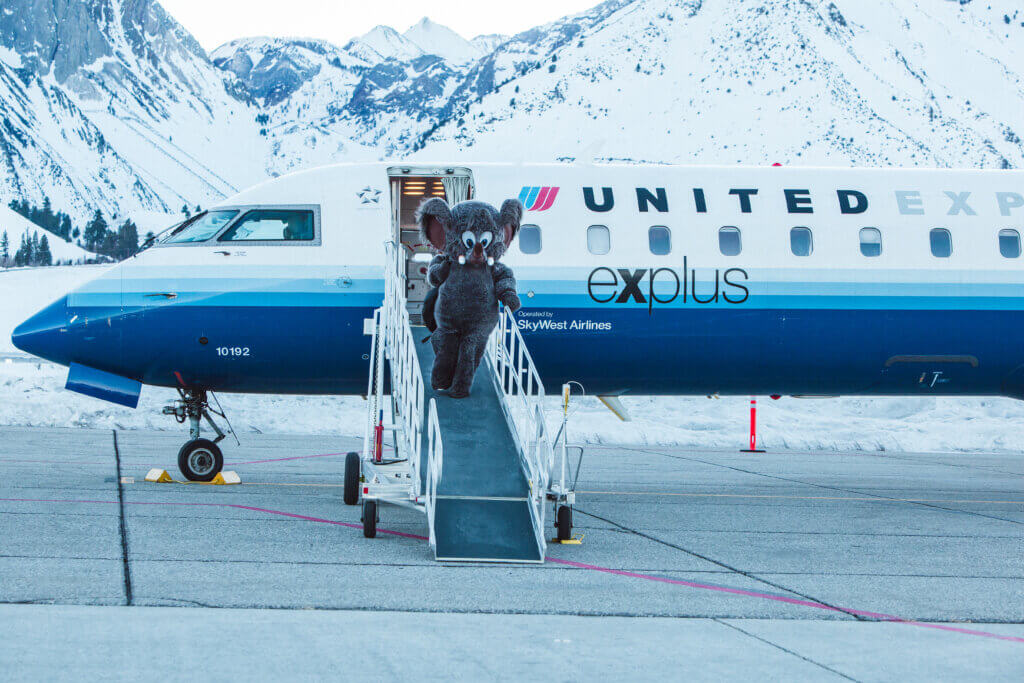 Mammoth Mountain's mascot exiting a plane.