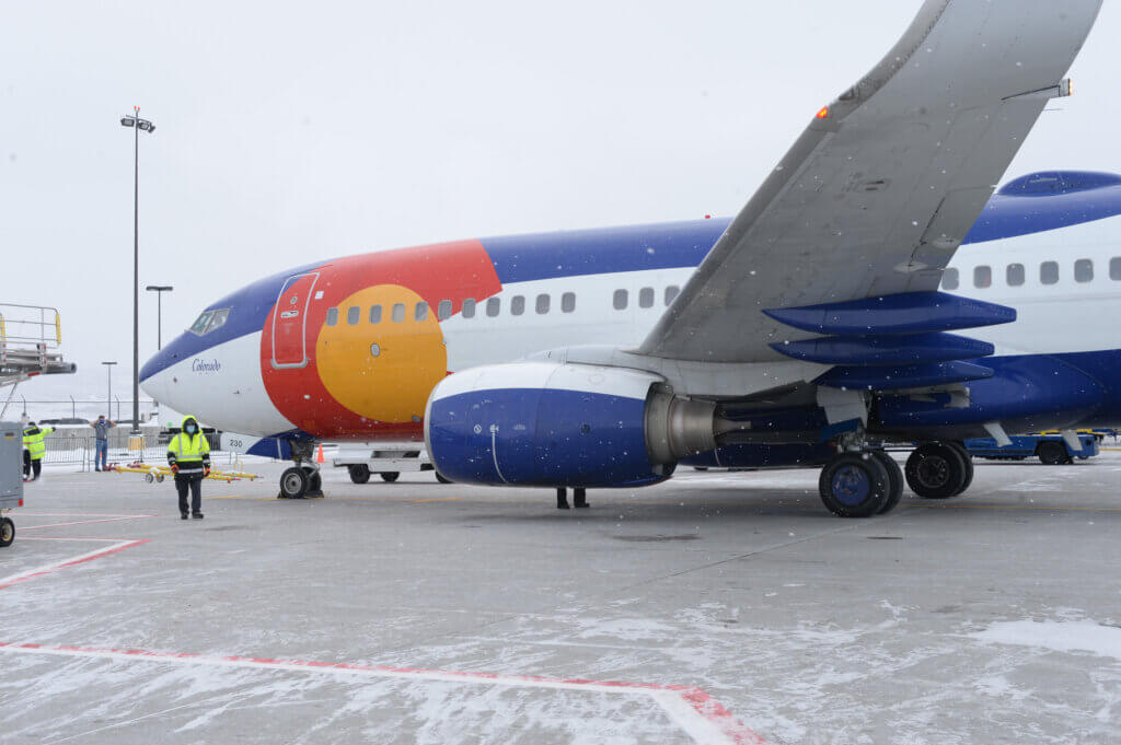 Airplane with a Colorado state flag decal on the side.