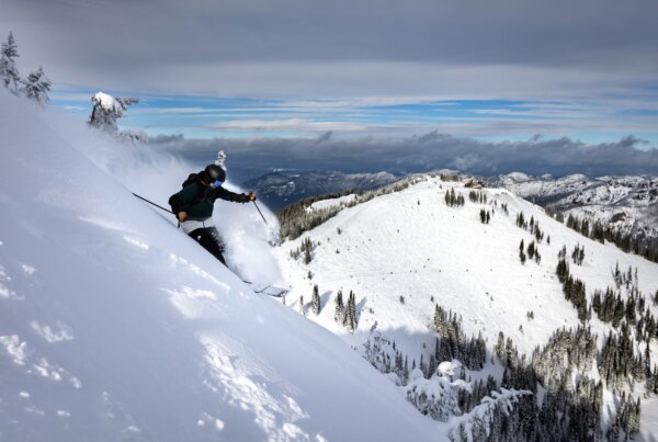 Skier riding down a steep hill.