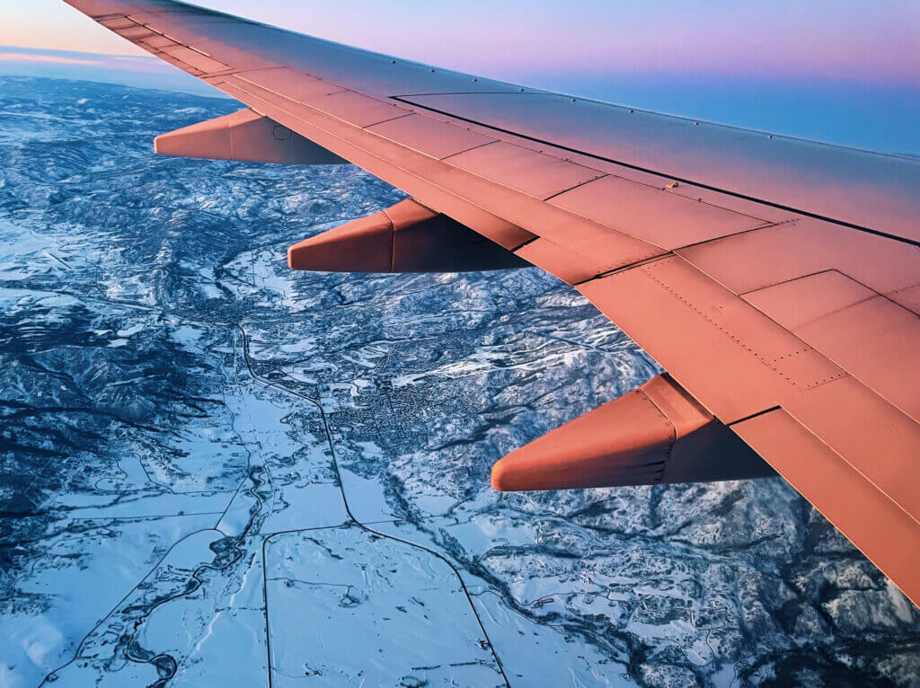 Aerial view or an airplane overlooking a mountain range.