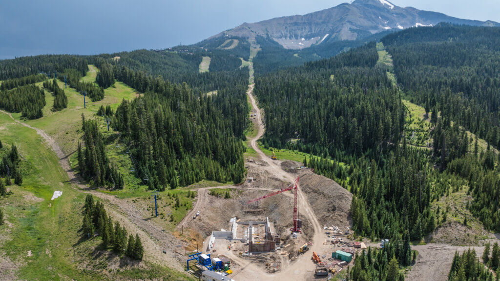 Aerial view of construction equipment doing work on a mountain.