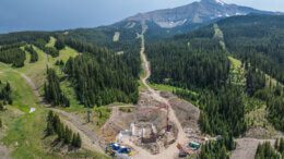 Aerial view of construction equipment doing work on a mountain.