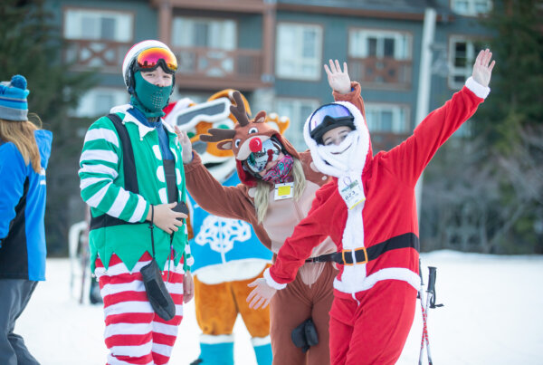 Group of people dressed as Christmas characters.