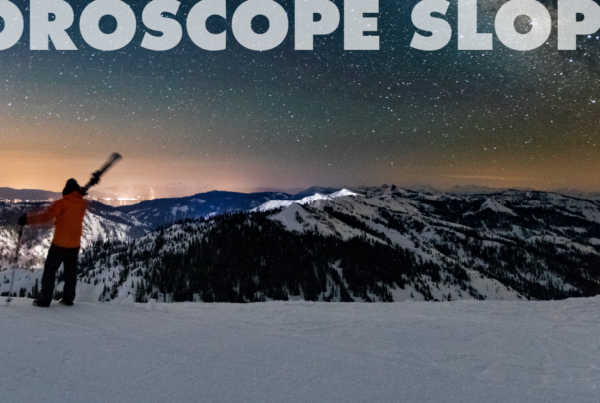 Skier standing on top of a ski run at dusk with the words "Horoscope Slopes" written along the top.