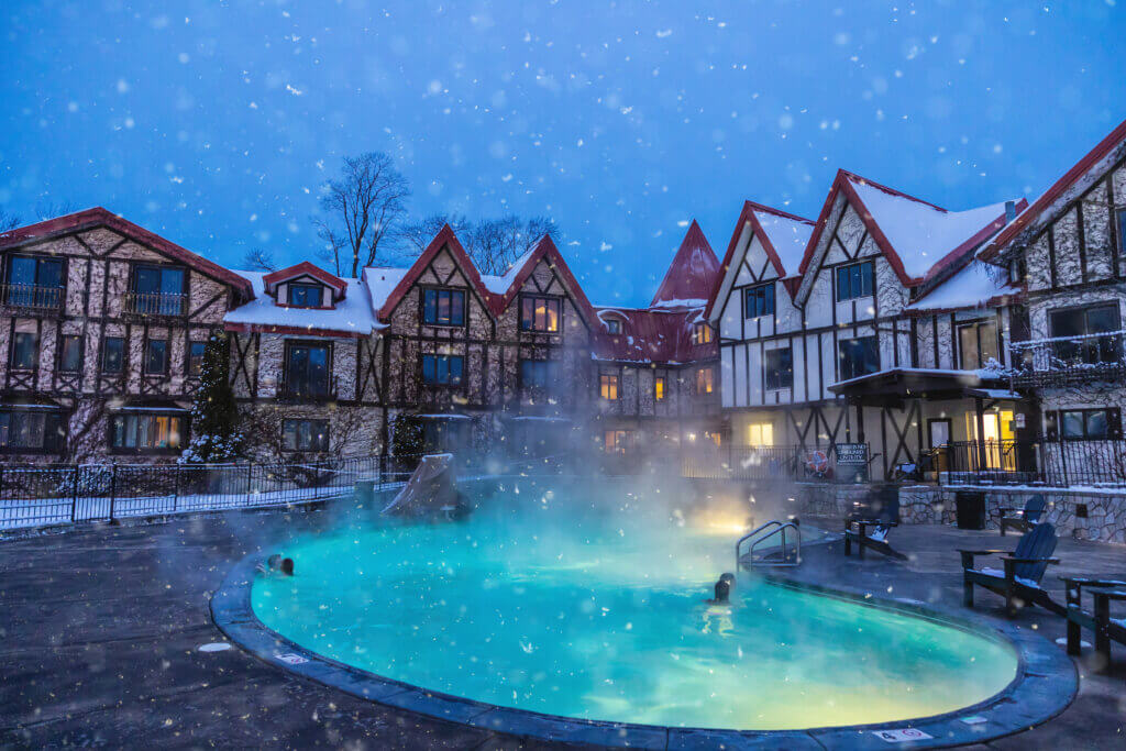 Lodge with a hot tub at night.