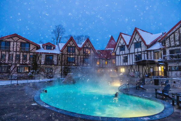 Lodge with a hot tub at night.