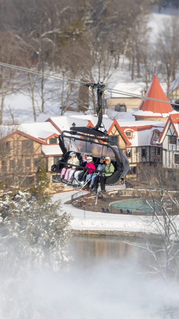 kids on chairlift over lodging at the Highlands Resort.