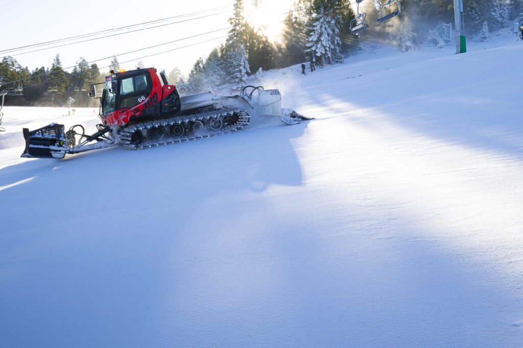 snowcat in action on mountain slope