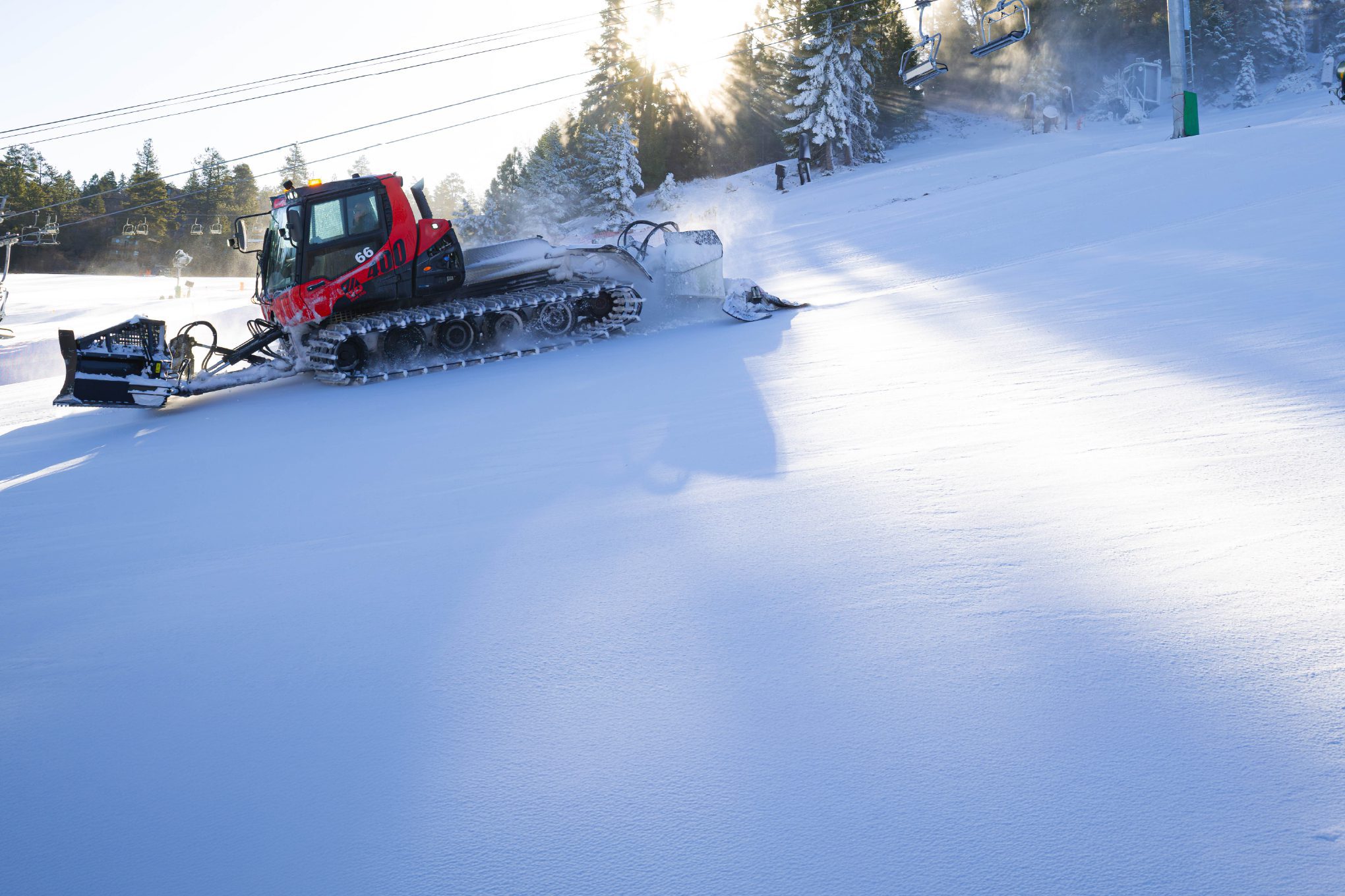 snowcat in action on mountain slope