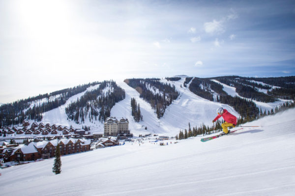 Athlete skiing groomed terrain at Big Sky Resort in Montana, one of the biggest destinations on the Ikon Pass