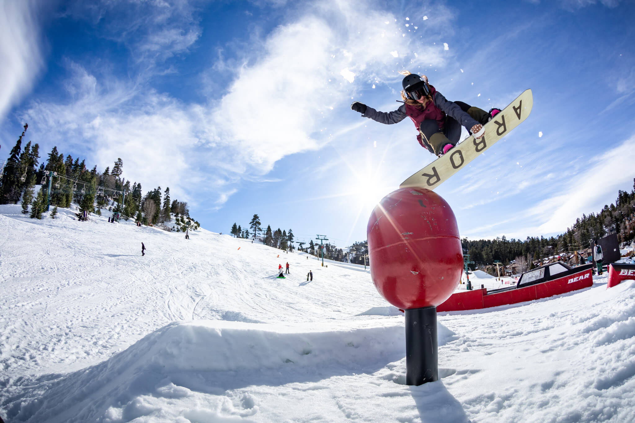 Snowboarder doing a trick at the terrain park at Big Bear Mountain Resort in California