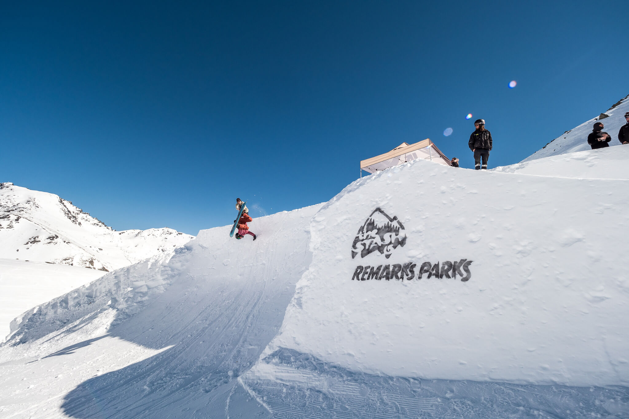 Snowboarder hitting a jump at The Remarkables ski resort in New Zealand, Southern Hemisphere