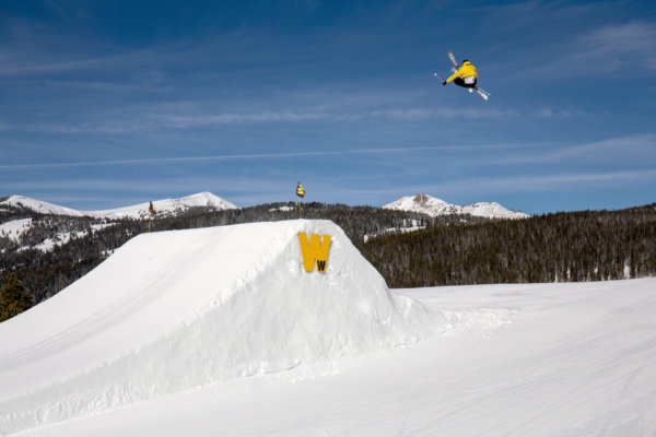 Skier going off a jump at Woodward terrain park at Copper Mountain