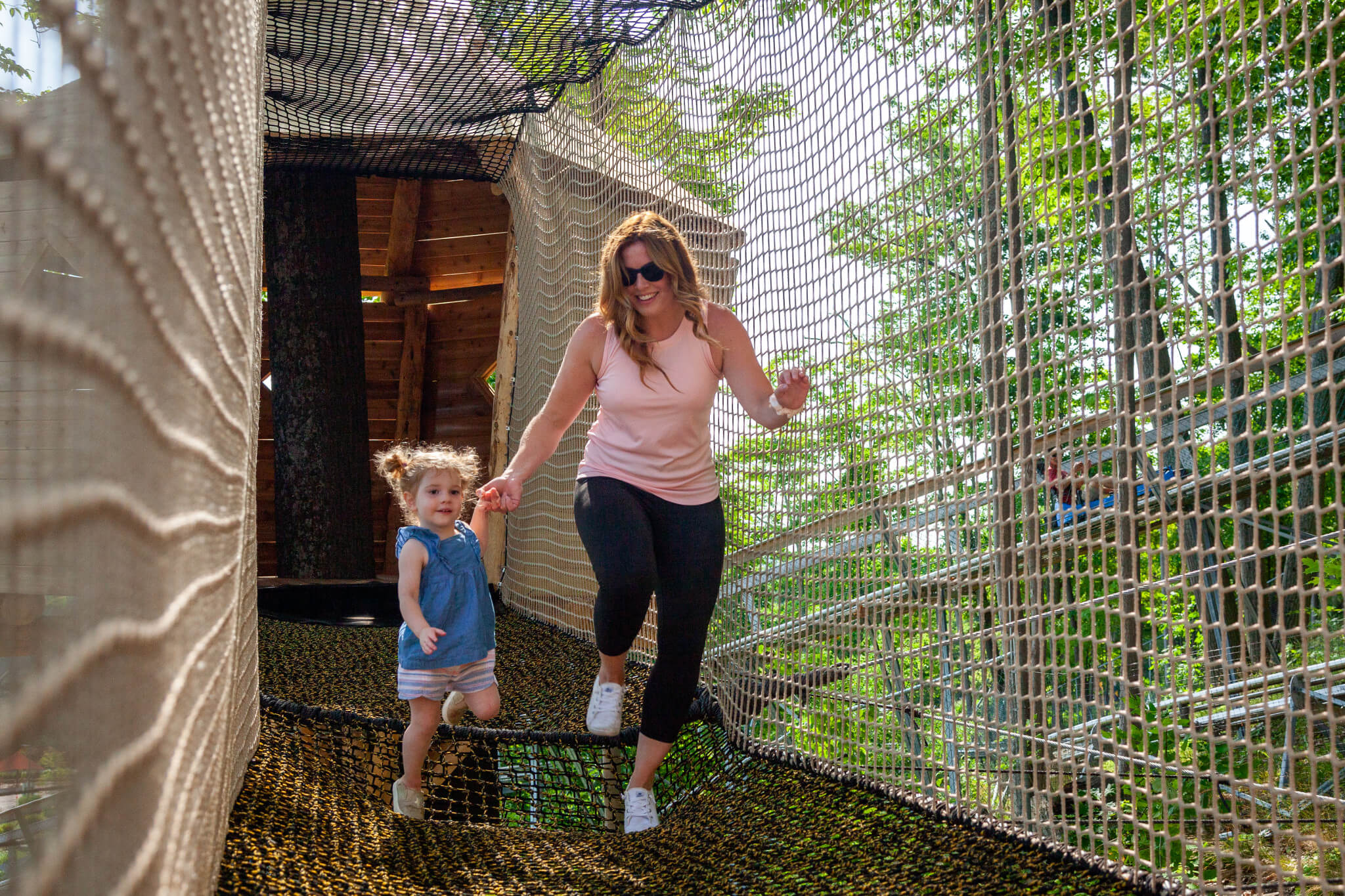 Young mom with her daughter in the bounce nets at Blue Mountain